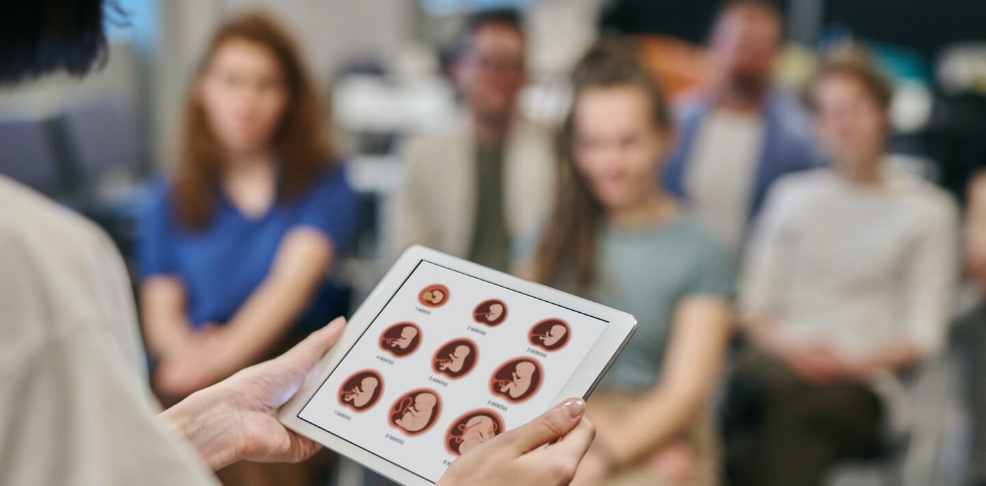 A group of pregnant women in a class setting