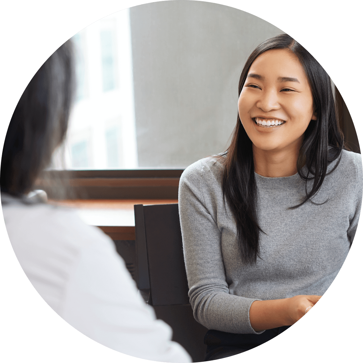 A woman smiling at her doctor