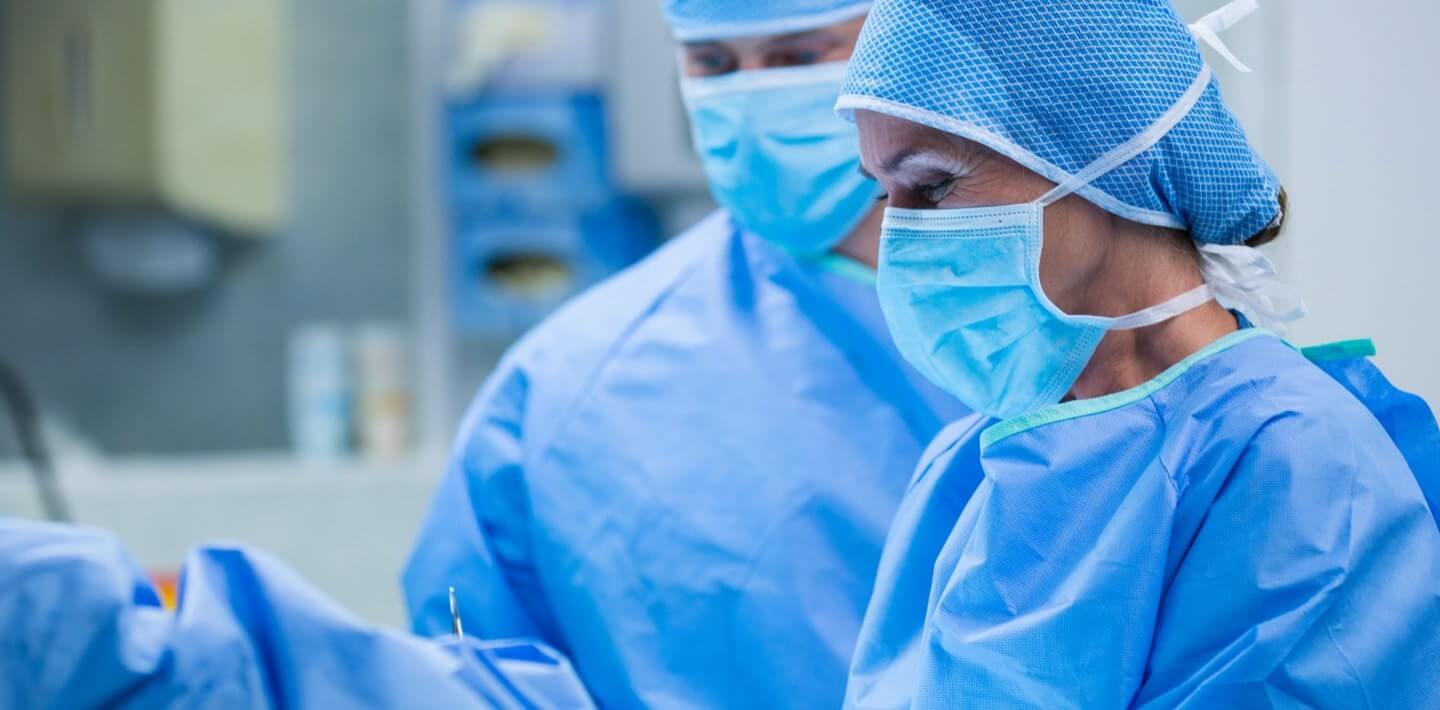 Close up of a surgeon performing an operation with other doctors
