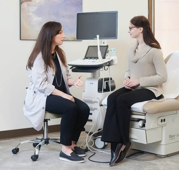 A doctor consulting a patient in an exam room