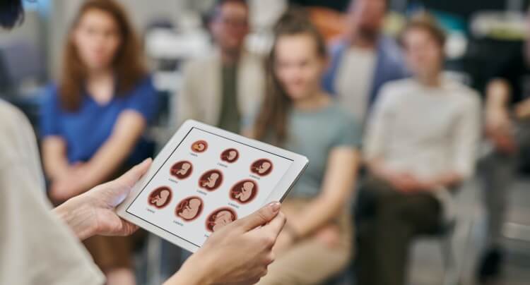 A group of pregnant women in a class setting