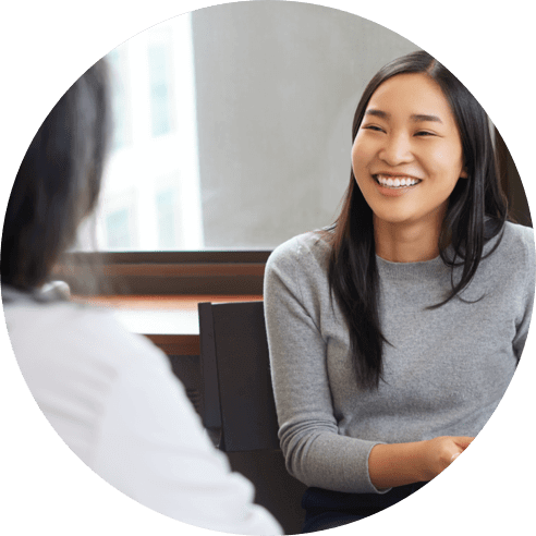 A woman smiling at her doctor