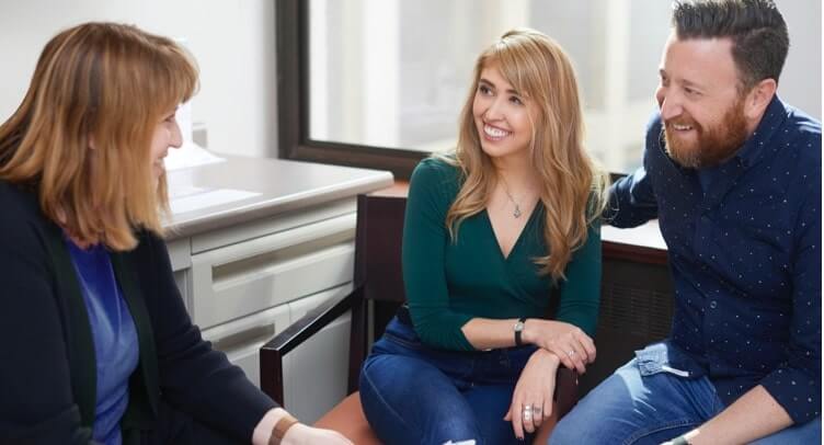 A fertility specialist speaking to a man and a woman