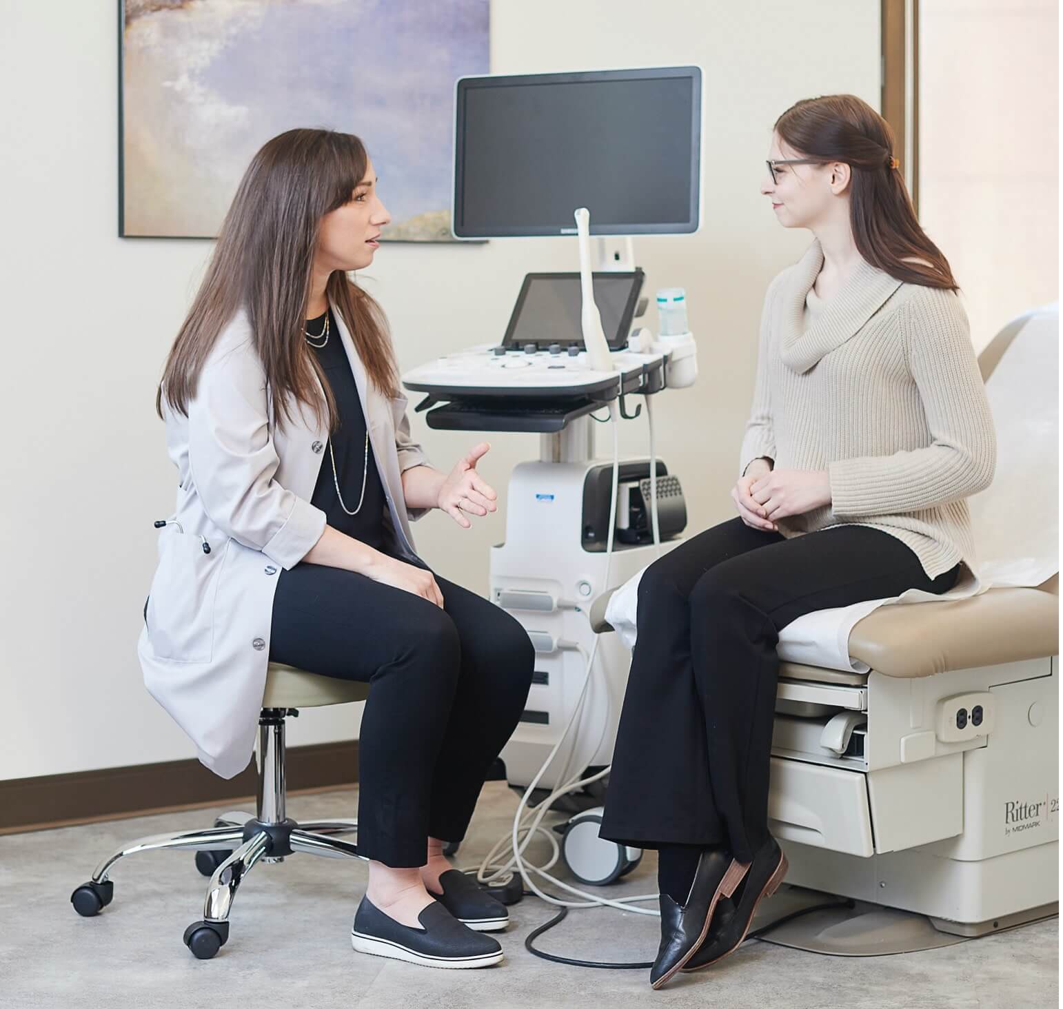 A doctor consulting a patient in an exam room