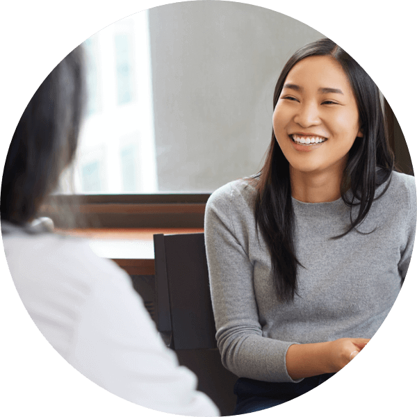 A woman smiling at her doctor