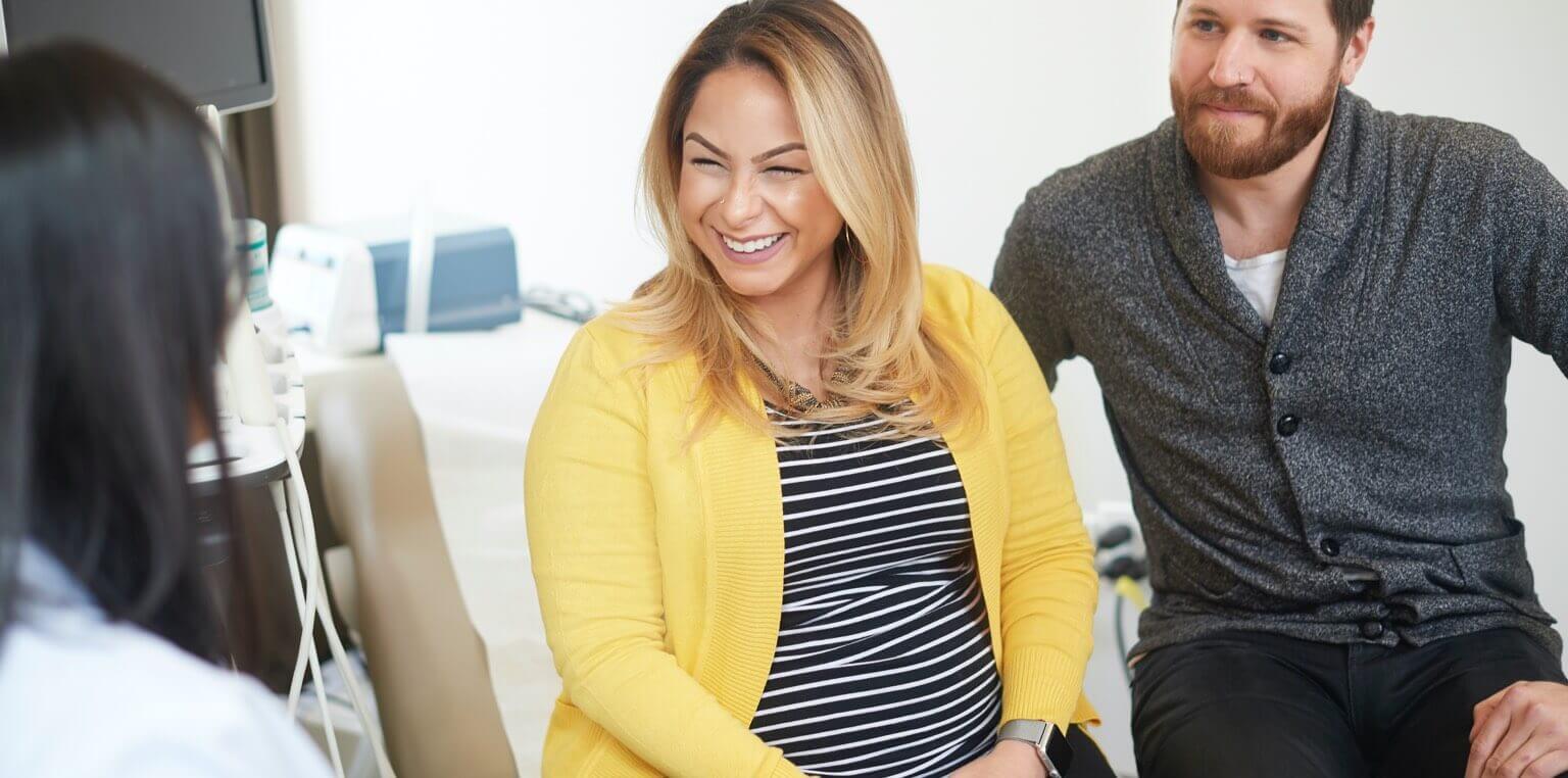 A doctor speaking to a couple about medical care